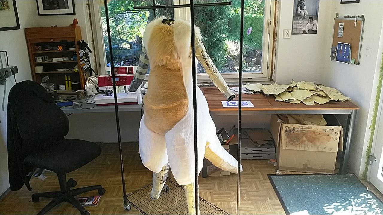 A wraparound shot of a mostly-furred bodysuit, all but the arms and lower legs complete.