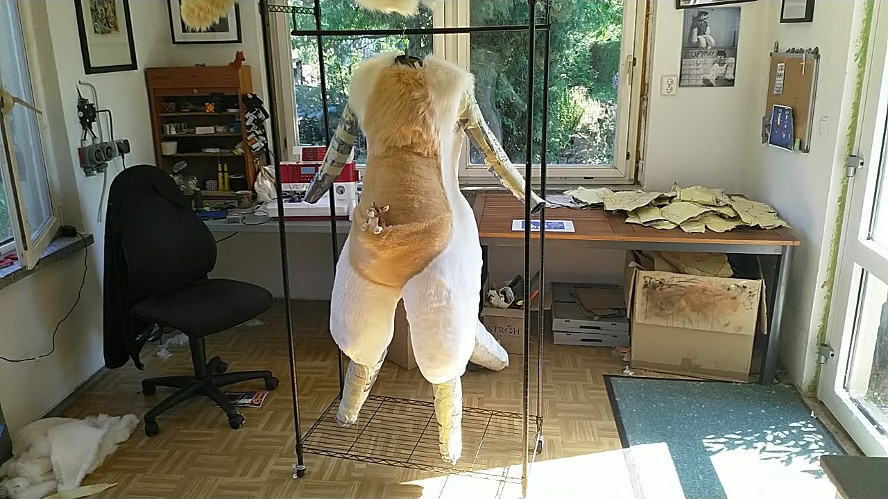A wraparound shot of a mostly-furred bodysuit, all but the arms and lower legs complete.
